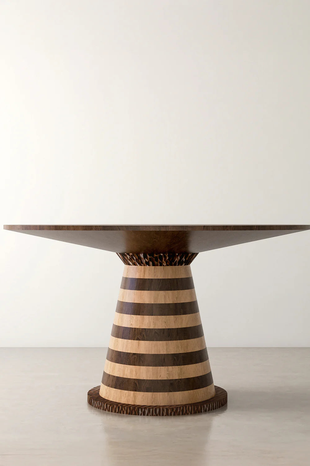 View of a wooden round dining table with striped pedestal base furniture