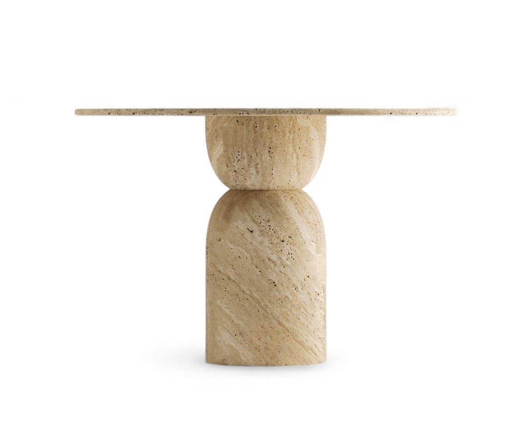 Round travertine dining table with sculptural stacked base, front view on white background.