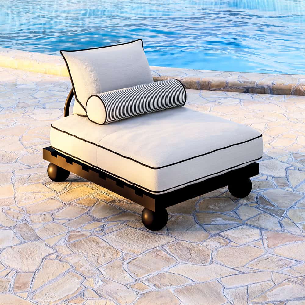 Outdoor chaise lounge with white cushion and striped bolster by pool