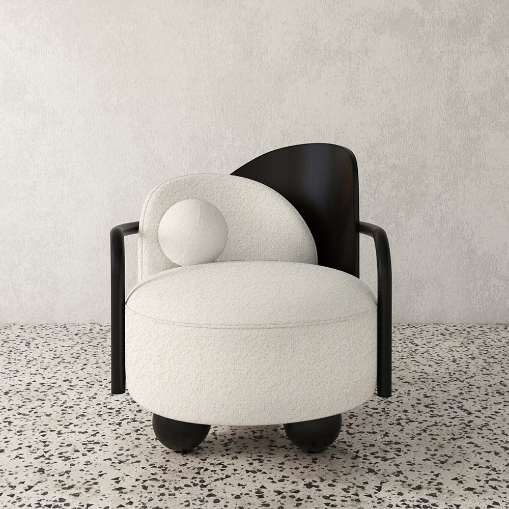 View of modern white boucle armchair with black wood accents, terrazzo floor, white wall, contemporary furniture.