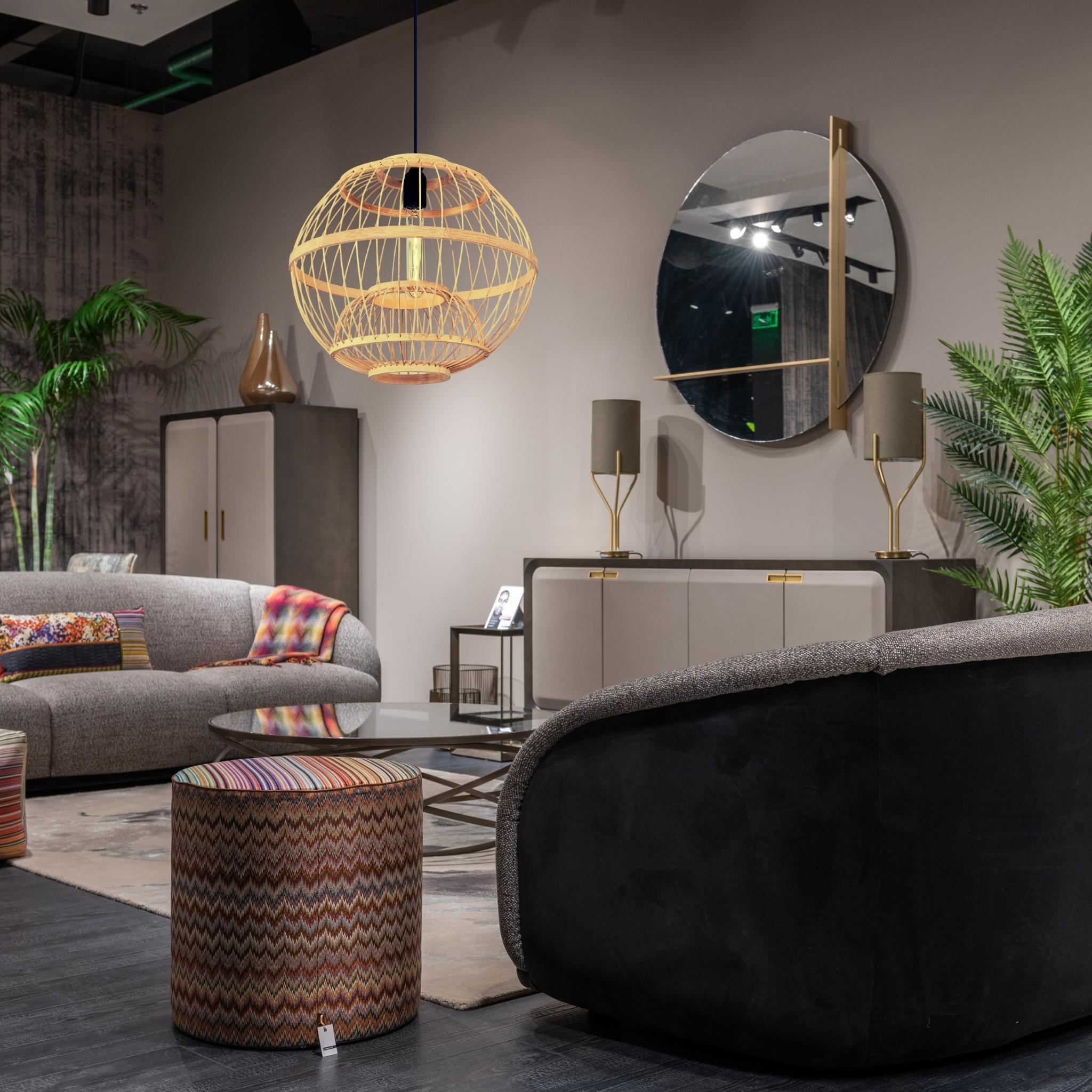 Modern living room with curved sofa, colorful ottoman, and rattan light fixture.