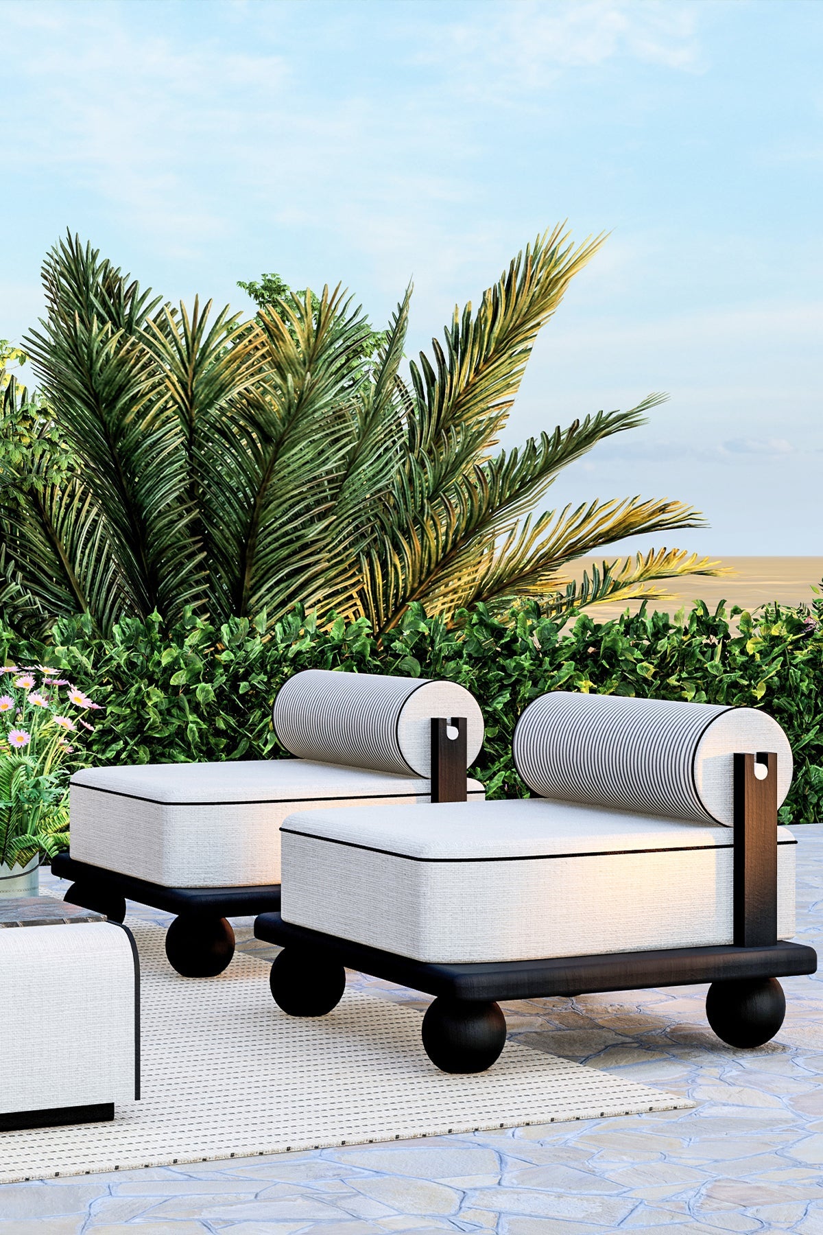 Outdoor seating furniture with white cushions and striped bolsters on patio.