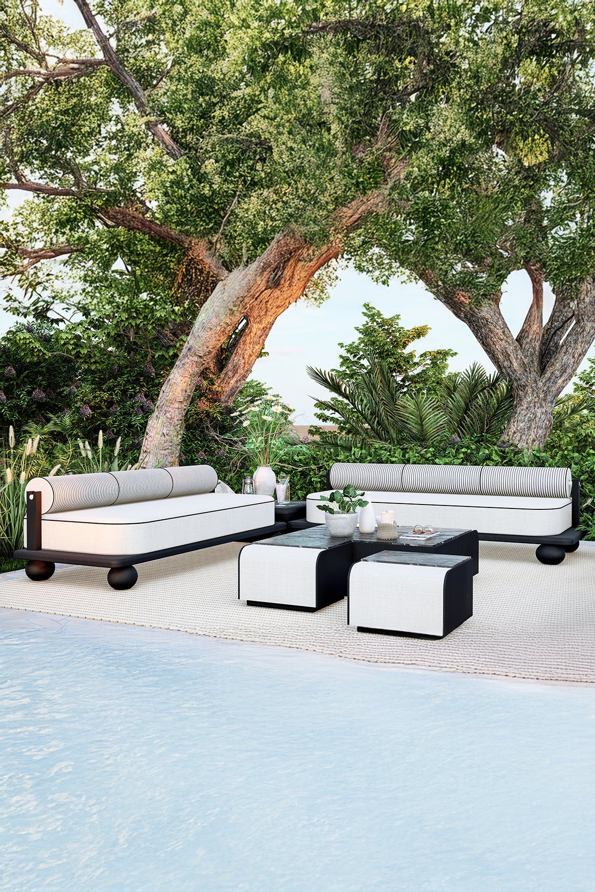 Outdoor seating area with two sofas, coffee table, rug, near pool.