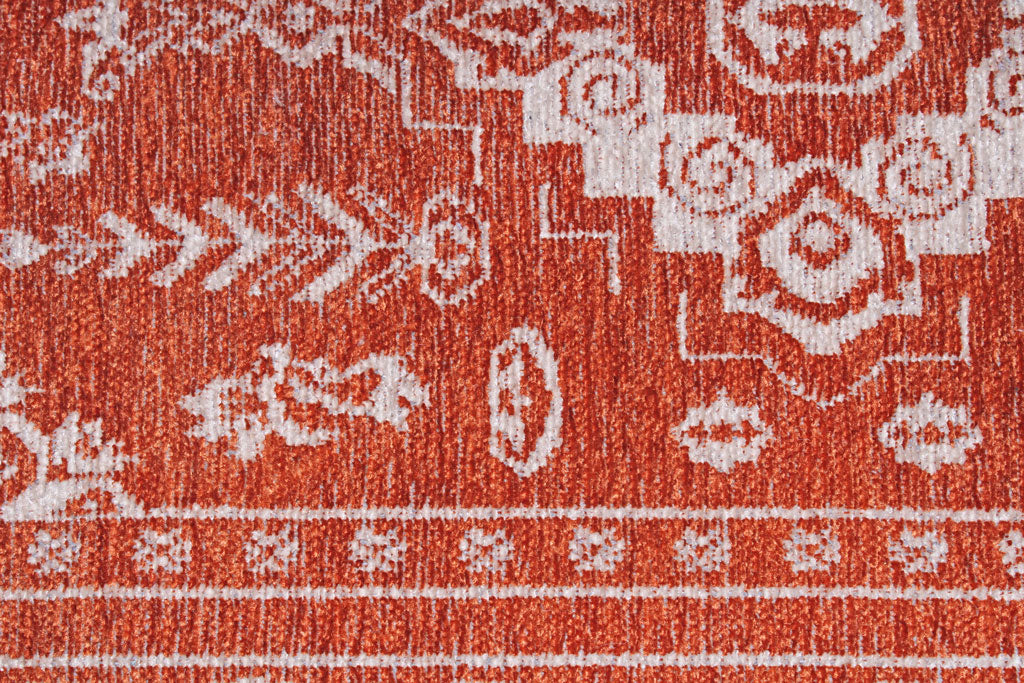 Close up view of orange and white patterned rug texture