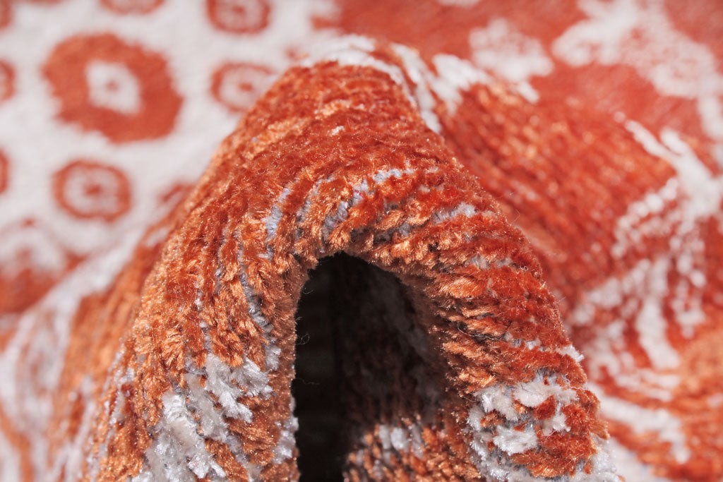 Close up of orange and white patterned rug pile texture