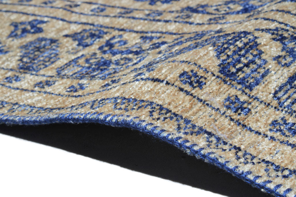 Close up of beige and blue patterned rug edge