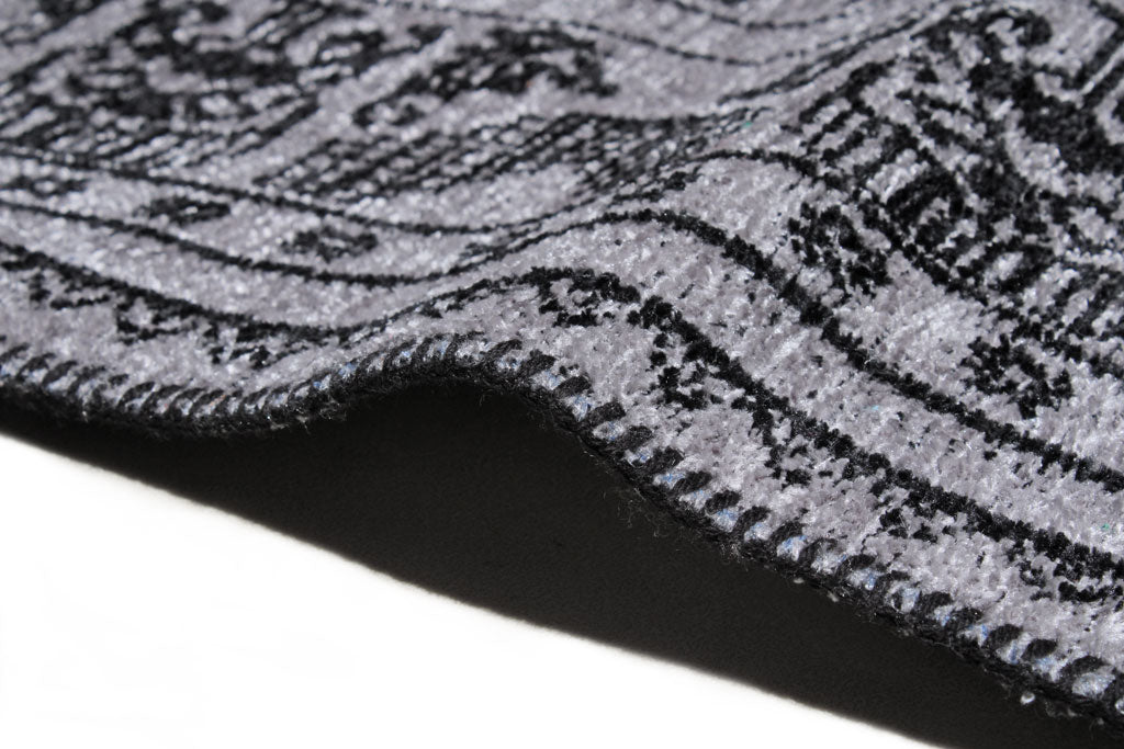 Close-up of gray and black patterned rug showing edge