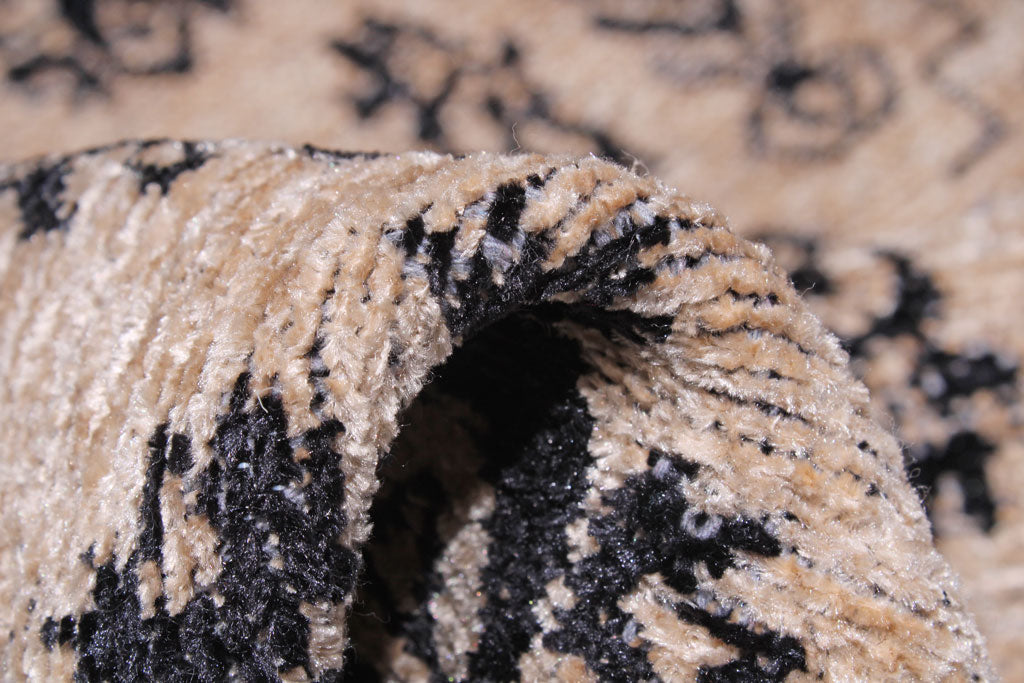 Close up of beige and black patterned rug fibers