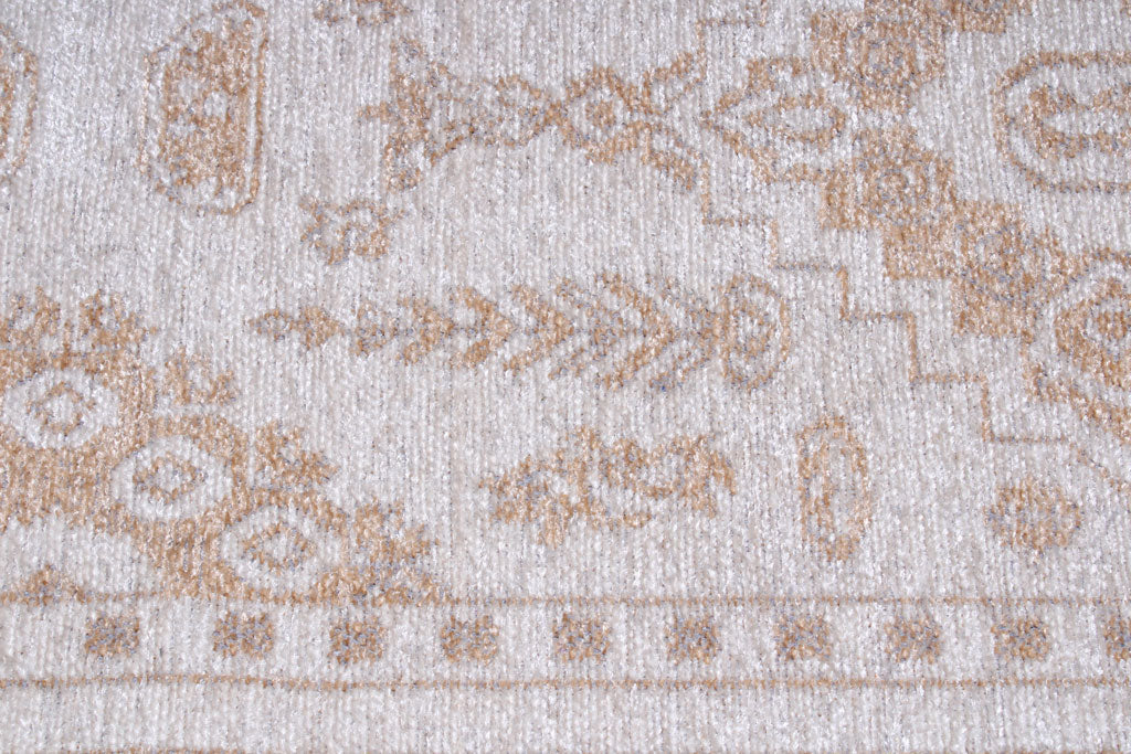 Close-up view of beige and white patterned rug texture