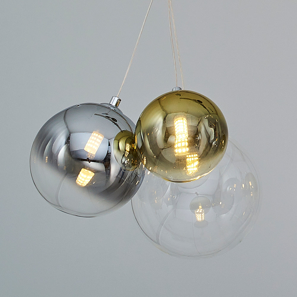 Close up view of three glass sphere pendant lighting fixtures