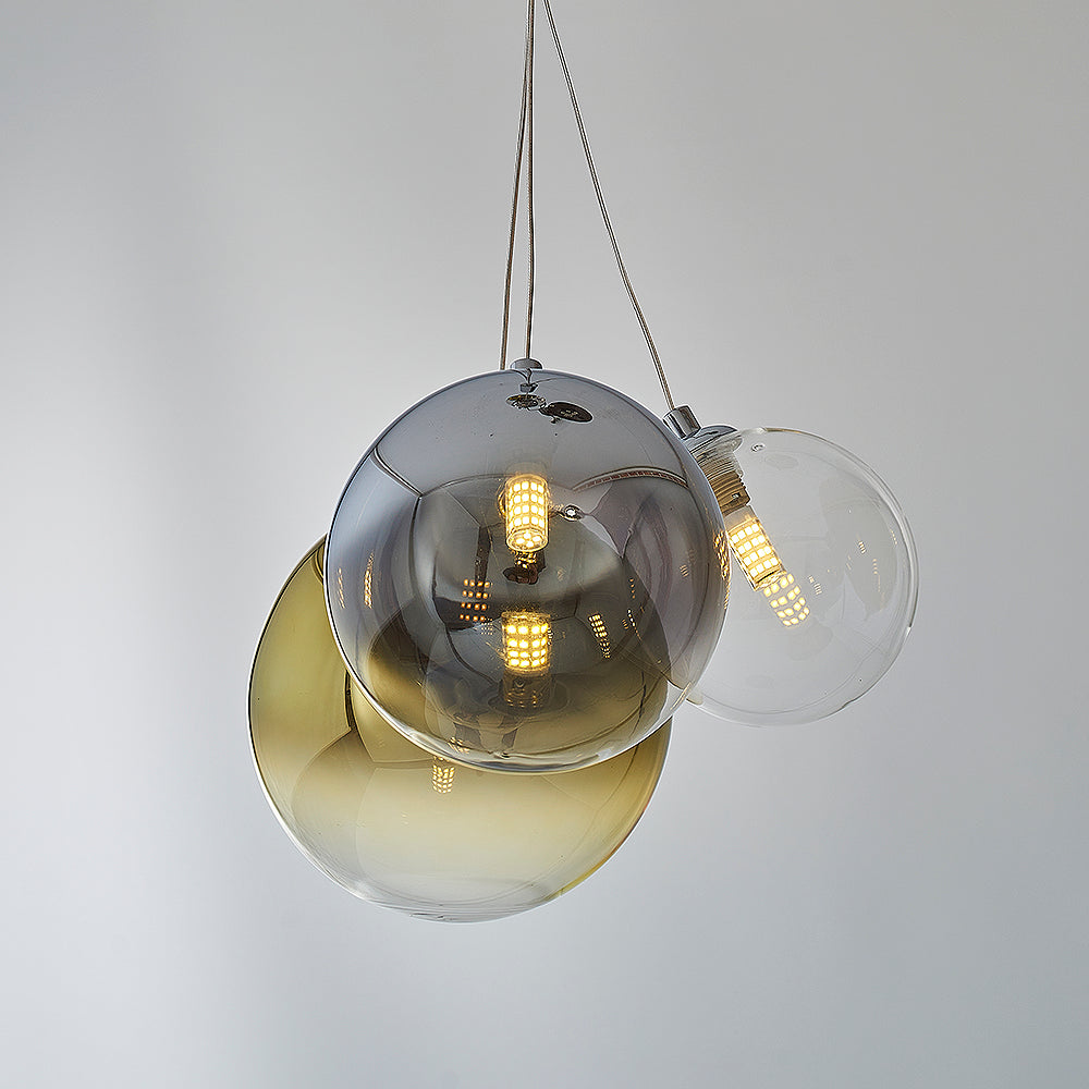 Close up view of glass sphere pendant lighting fixture with LED bulbs. 