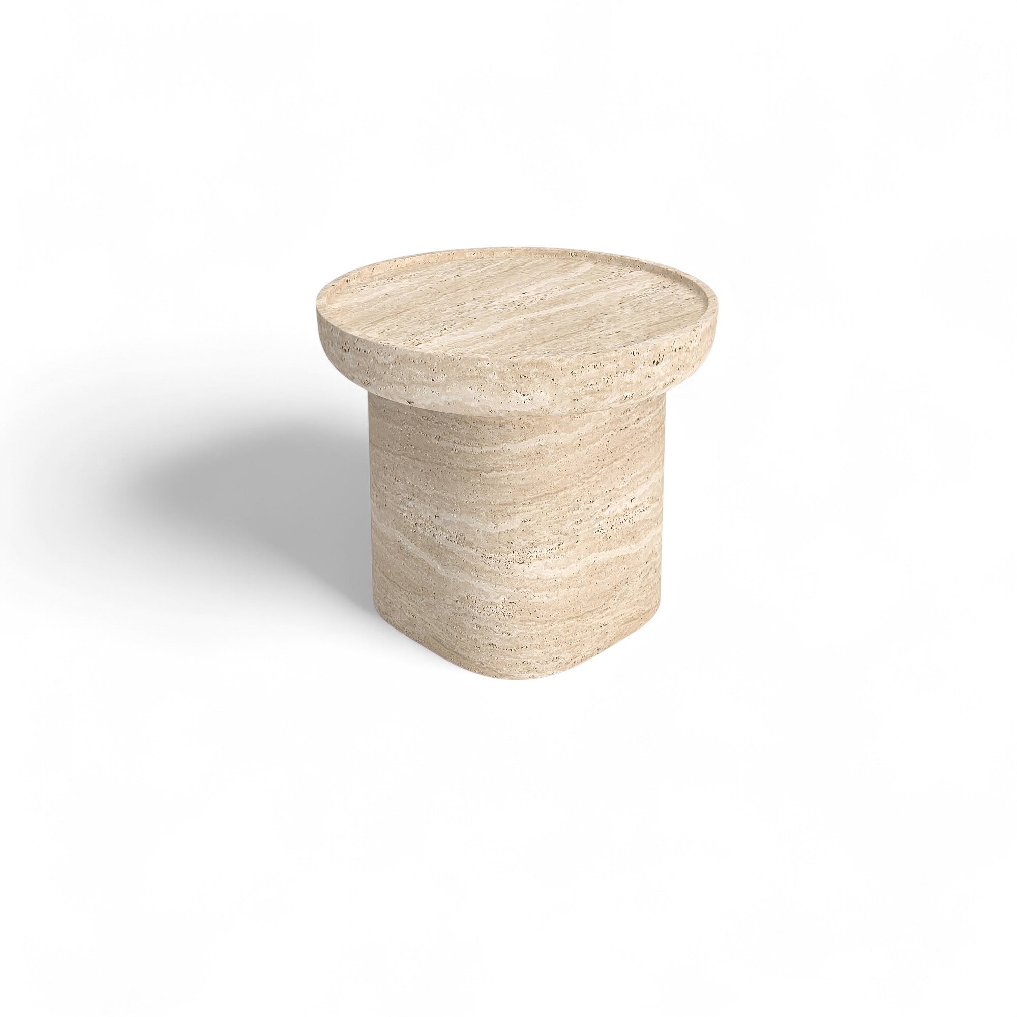 Studio shot of round travertine side table on white background. Travertine furniture, stone side table, round end table, natural stone decor.