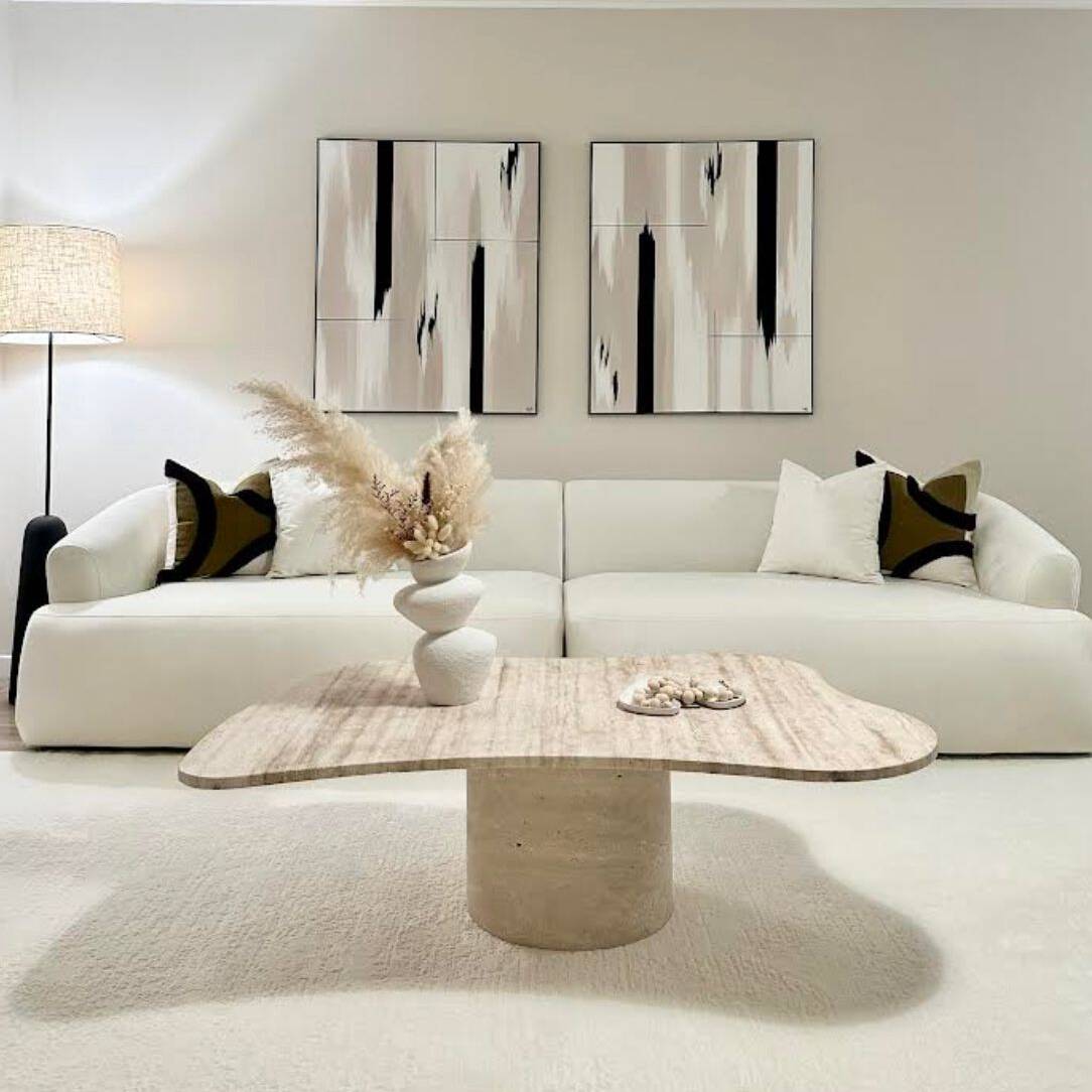 Modern living room with white modular sofa, travertine coffee table, minimalist decor, and contemporary furniture by Luzione
