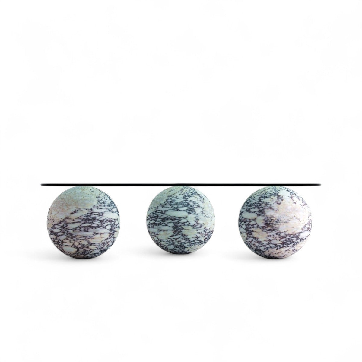 Three marble egg shaped bases support glass table top