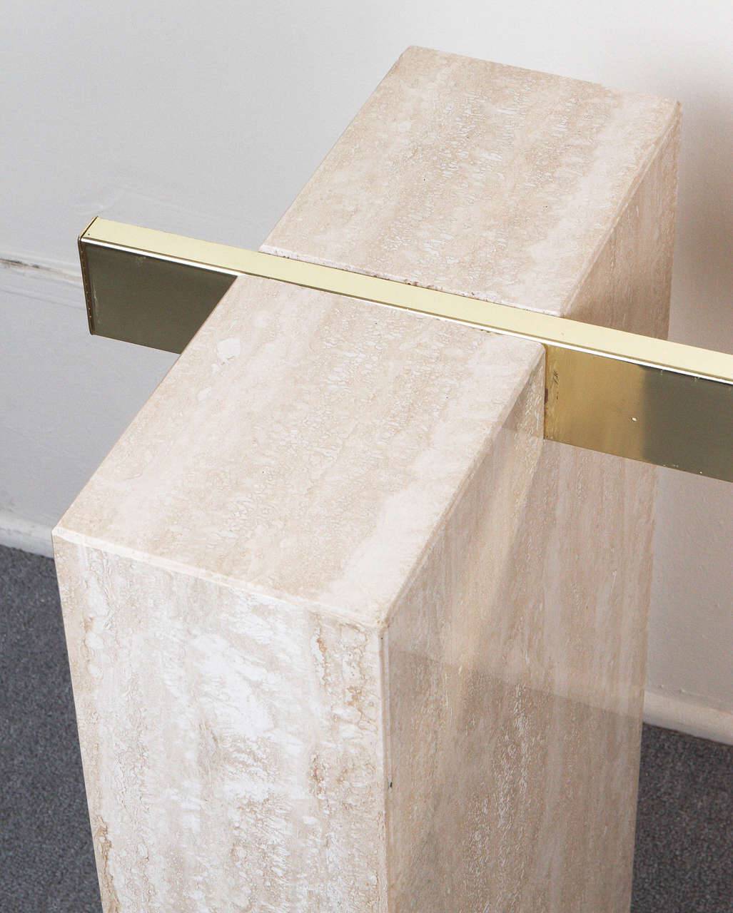 Close-up of Luzione travertine console table with brass accent, showcasing modern design and natural stone finish for luxury home decor