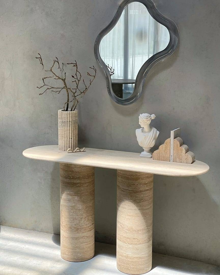 Luzione Espoir marble console table with cylindrical legs and modern mirror against a gray wall. Minimalist entryway decor and luxury furniture