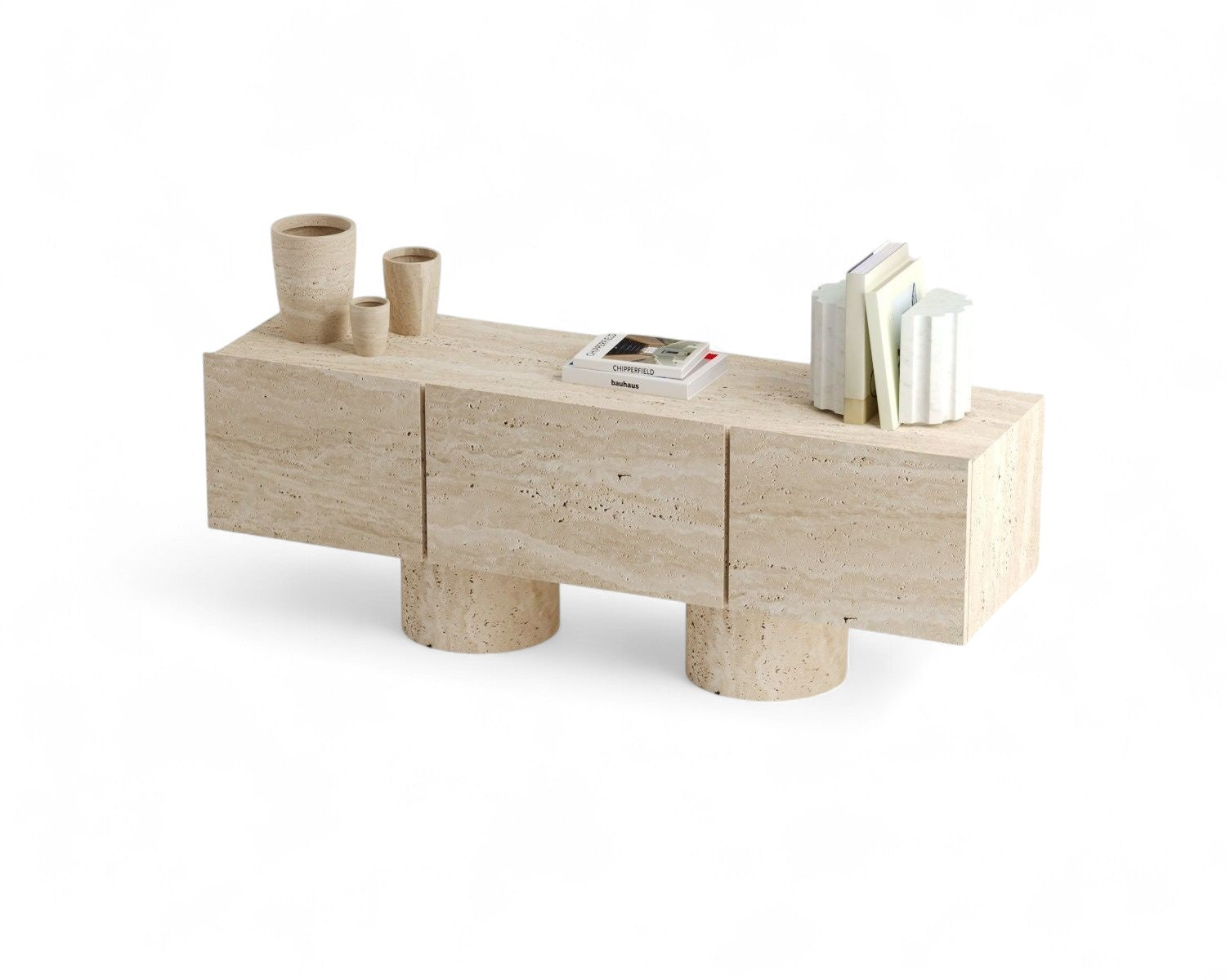 Travertine console table with cylindrical legs and decorative objects on top