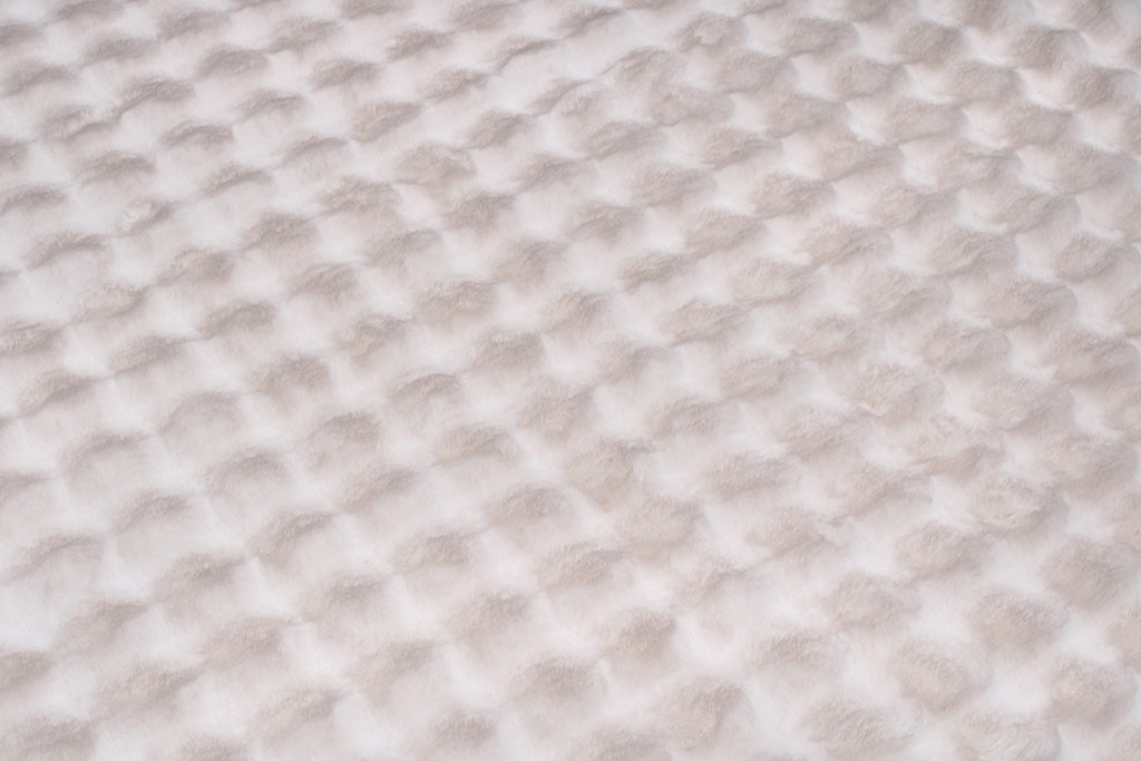Close up view of white textured fabric blanket pattern