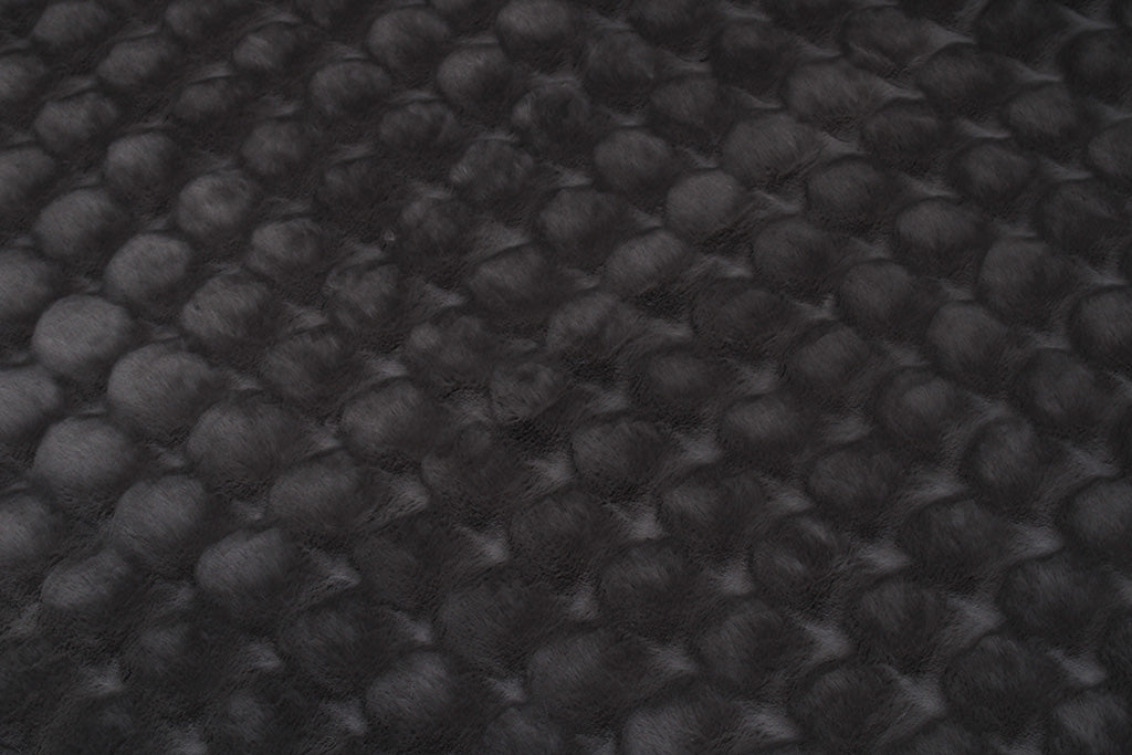 Close up view of dark gray textured blanket fabric