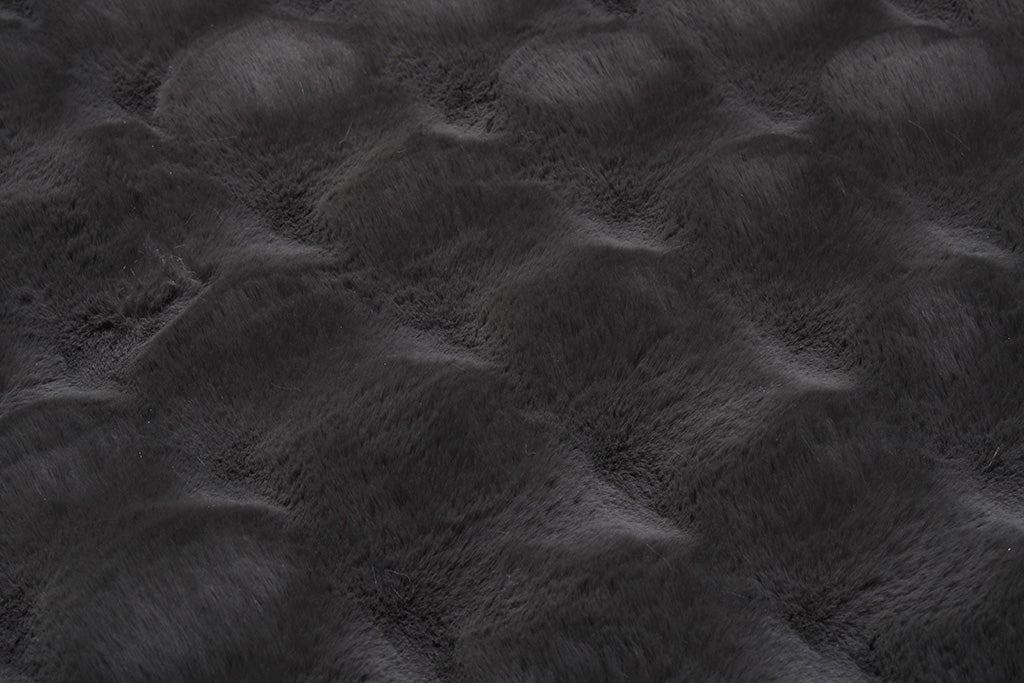 Close up view of dark gray faux fur fabric texture