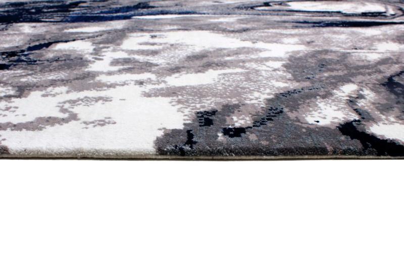 Close up view of abstract gray white blue rug edge