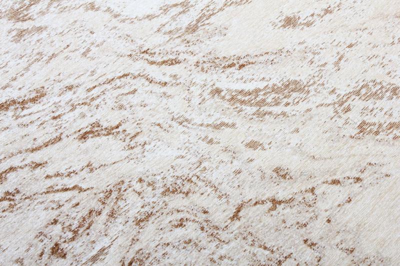 close up view of rug with white and brown abstract pattern