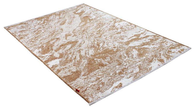 Overhead view of rectangular rug with brown and white abstract pattern.