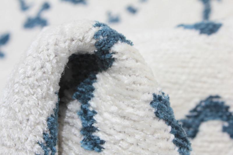Close up of white and blue patterned rug texture