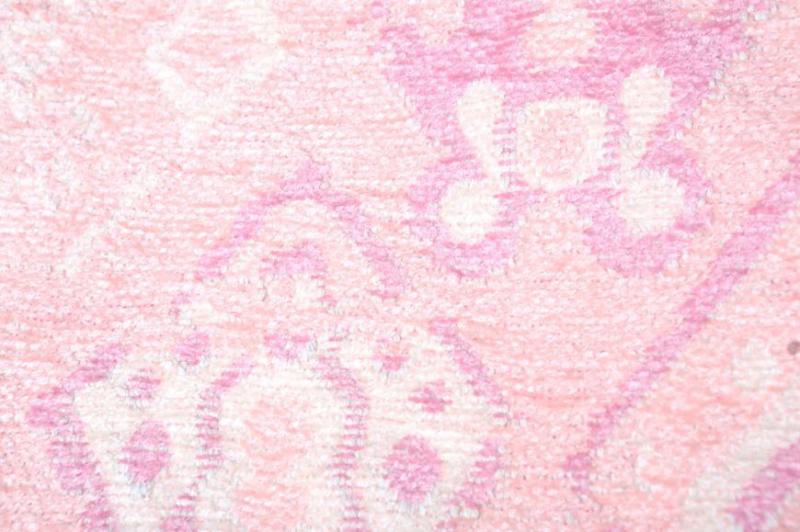 Close up view of pink patterned area rug texture