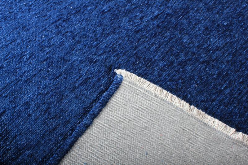 Close-up of Moretti Plain Rug's texture, highlighting the quality of its beige fibers. Natural Beige under for a minimalist touch.