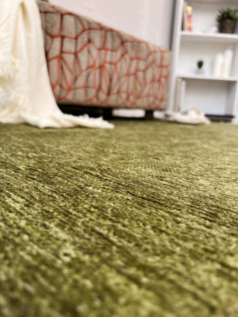 Moretti Plain Rug placed in a tranquil reading nook, adding warmth and simplicity to the space.
