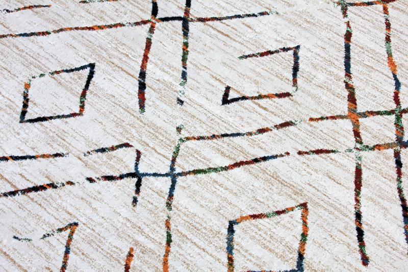 Close up view of rug with abstract multicolored line pattern