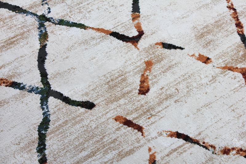 Close up view of white rug with abstract brown and black lines