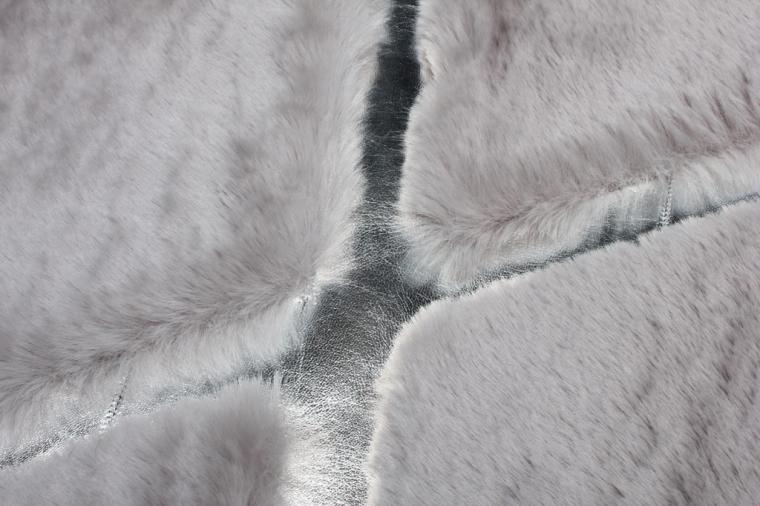 Rabbit Fur Rug placed in a serene bedroom, adding warmth and elegance with its gray and silver hues.