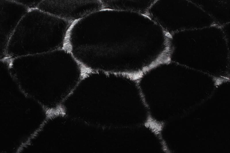 Close-up of Rabbit Round Fur Rug's soft texture, highlighting the luxurious feel of the black and silver fur.