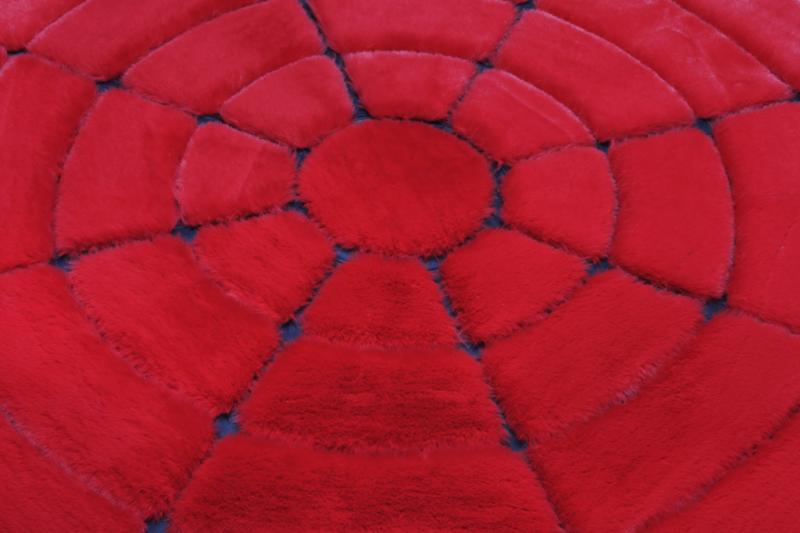 Close-up of Rabbit Round Fur Rug's vibrant red and black fur, highlighting the richness of its colors.