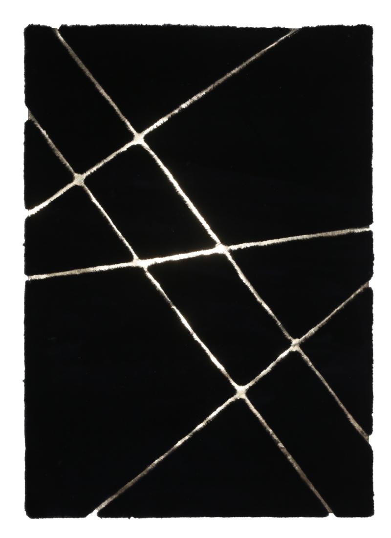 Front view of Rabbit Fur Rug in black and gold tones, serving as a bold and luxurious centerpiece in a modern living room.