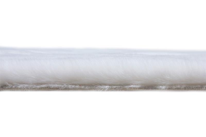 Angled view of Rabbit Fur Rug in a modern living room, highlighting its minimalist appeal.