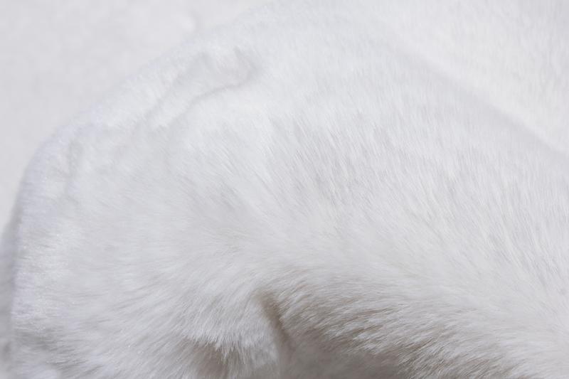 Rabbit Fur Rug placed in a serene bedroom, enhancing the space with its pure white elegance.