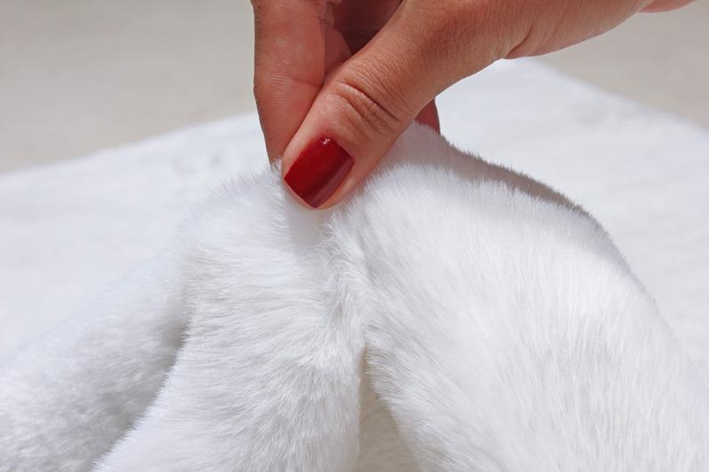 Rabbit Fur Rug placed in a serene bedroom, enhancing the space with its pure white elegance.