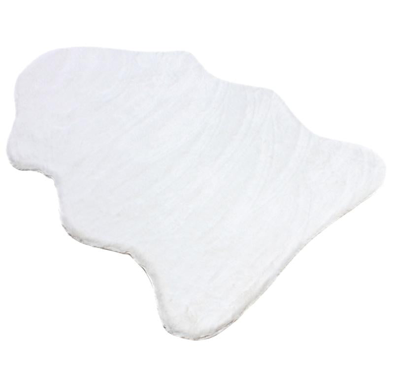 Close-up of the sheep-like texture of the cream rabbit fur rug, highlighting its cozy feel.