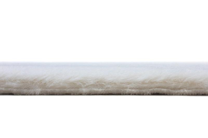 Cream sheep-textured rabbit fur rug in a living room, adding warmth and elegance.