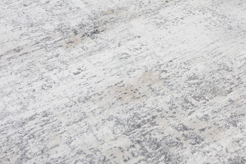 Close up view of white and gray abstract pattern rug