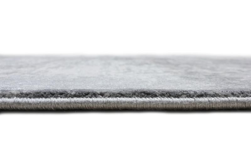 Close up view of gray rug edge on white background