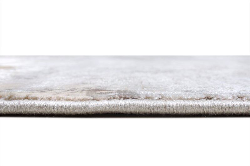 Close up view of white area rug edge and pile