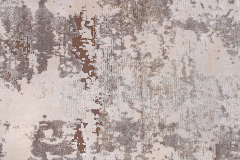 Abstract patterned rug with beige, brown, and gray colors