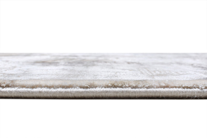 Close up view of light gray rug pile and edge