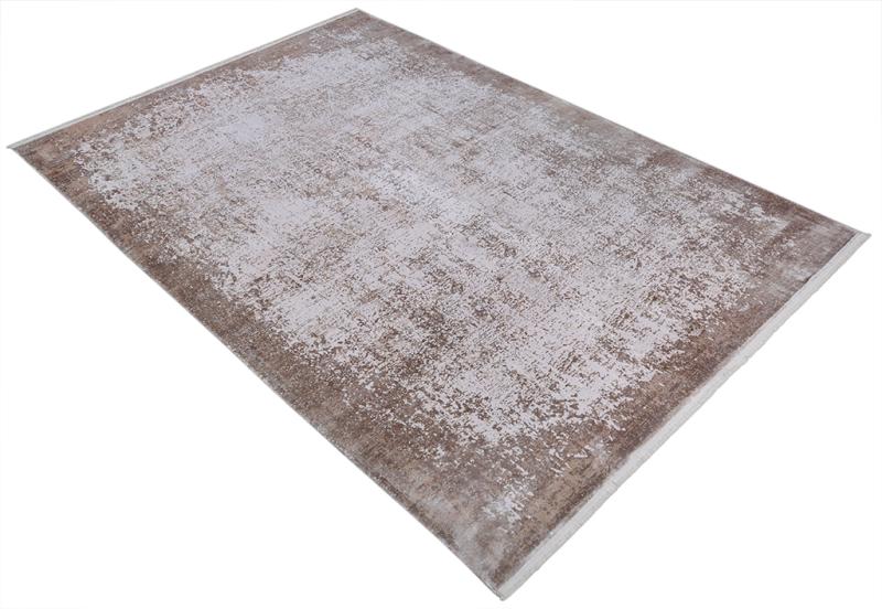 Rectangular brown and white distressed area rug on floor
