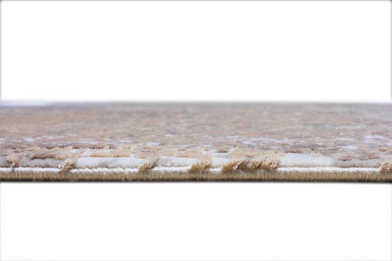 Close-up edge view of beige abstract pattern area rug texture