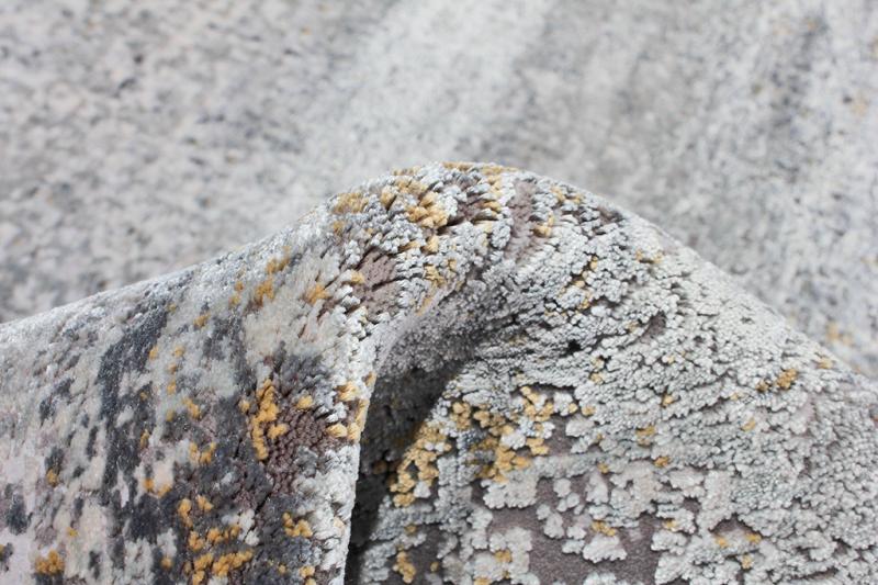 Close up view of gray and yellow patterned area rug texture